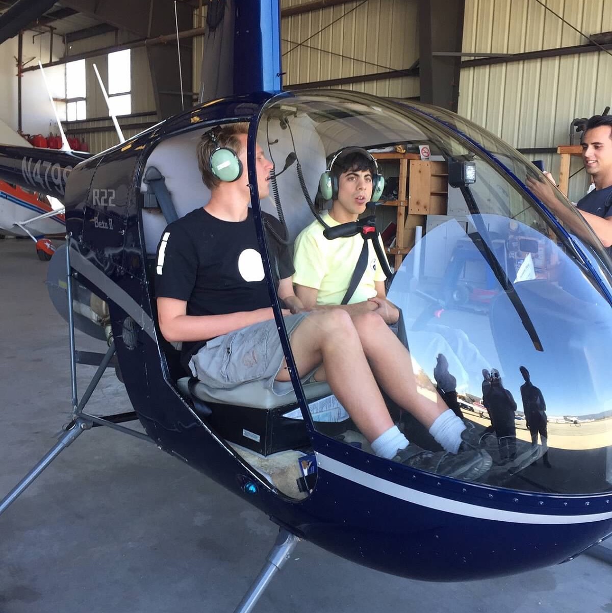 Two students sitting in a stationary helicopter